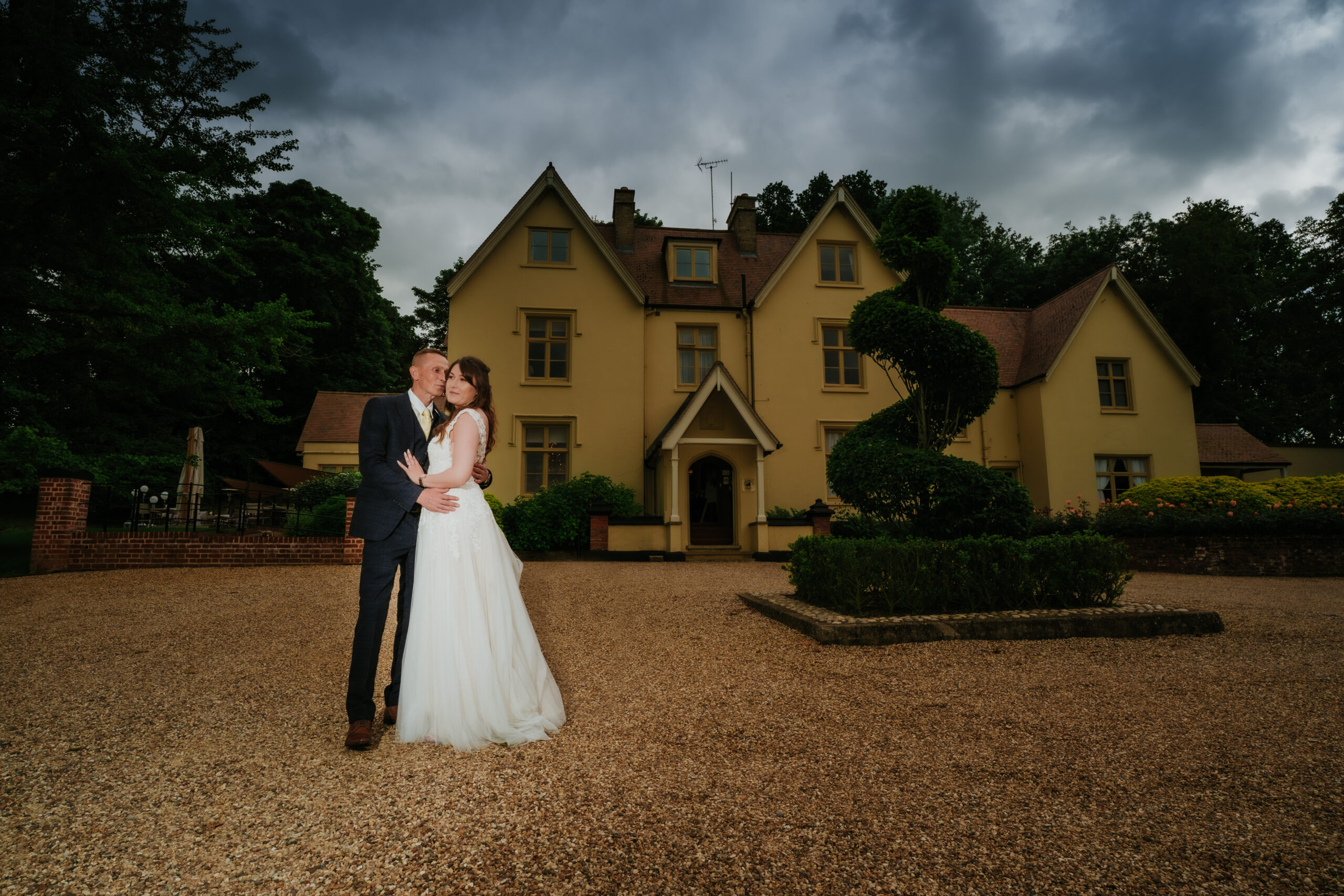 Recently married couple sharing an embrace at Maison Talbooth wedding venue in Essex