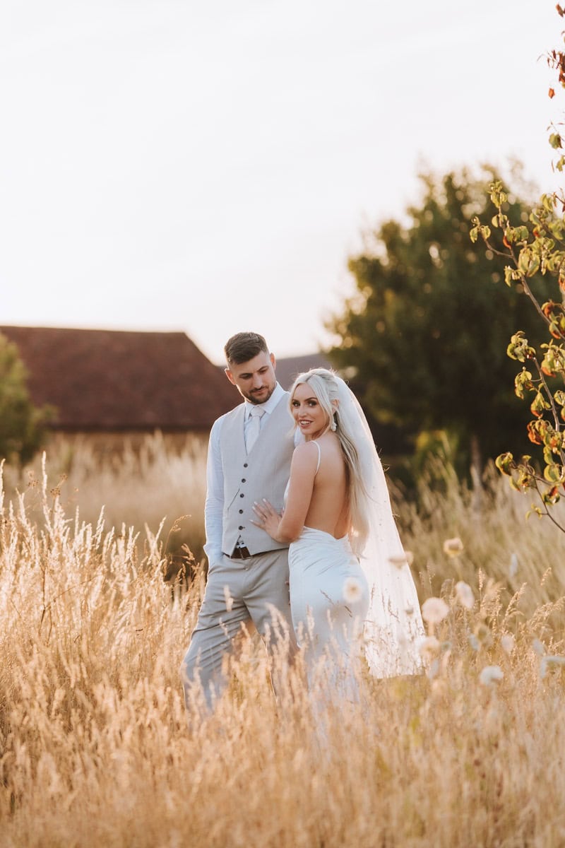 A newly married couple on their wedding at golden hour at primrose hill wedding venue in the cotswolds.
