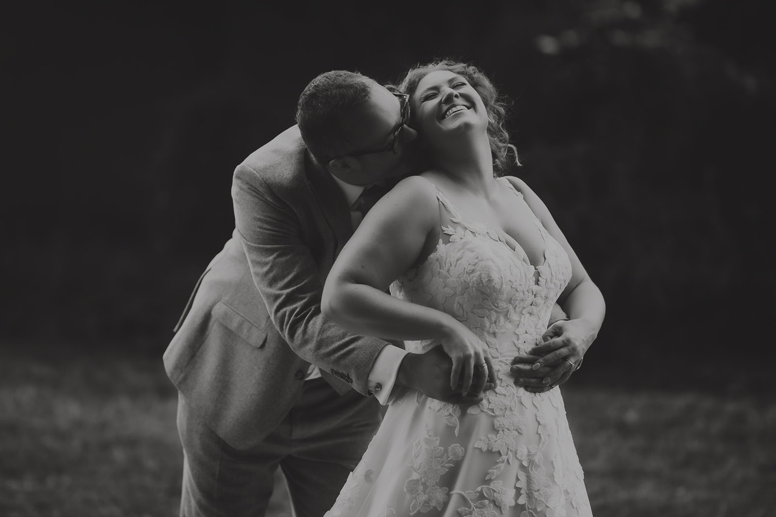 Rebecca and Dave sharing a candid laugh together at The Vines Rochester Park on their wedding day, photographed by Tel, Lily & White Photography