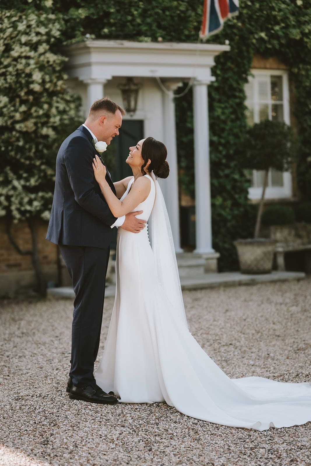 Bride and groom portrait in an elegant doorway at Friern Manor wedding venue in Brentwood, Essex — editorial photography by Lily & White